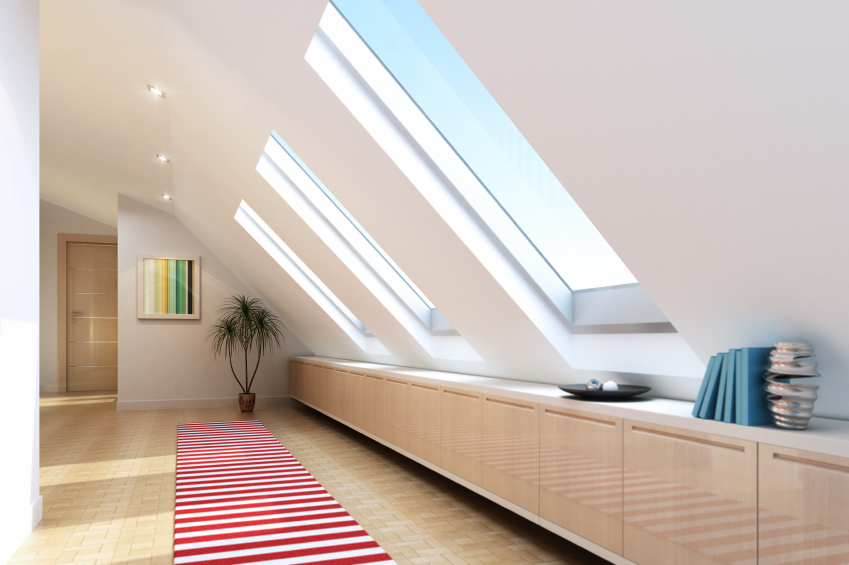 spacious-white-attic-room-design-with-skylights-window-decorated-with-wooden-cabinetry-and-striped-red-white-carpet