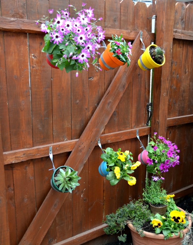 how to decorate your garden fence with some beautiful planters